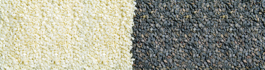 white and black sesame seeds lie side by side. Banner for insertion into site.