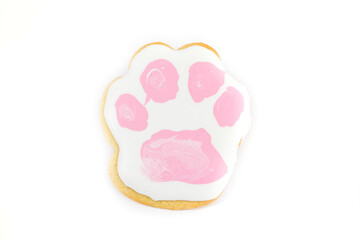 Puppy paw shape decorated with royal icing, sugar cookie isolated over white
