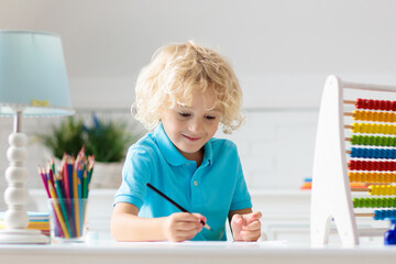 Child with abacus doing homework after school.