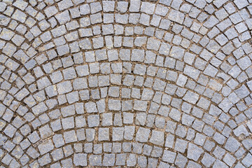 Granite cobblestone pavement background. Full frame of cobbles in arched rows. Natural stone...