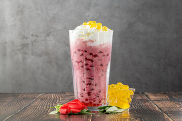 Strawberry, lemon and bubble tea milkshake or smoothie on wooden table