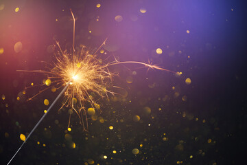 Happy New Year, Christmas Sparkler burning bright with shiny sparks and bokeh festive silvester party background