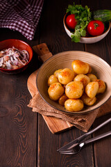 Fresh Cooked, new potatoes,with dill, on a wooden table, selective focus. close-up, toning, no people,