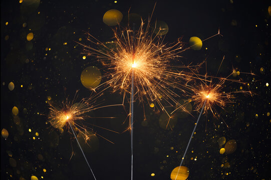 Happy New Year, Sparklers burning bright with shiny sparks and bokeh festive silvester party background
