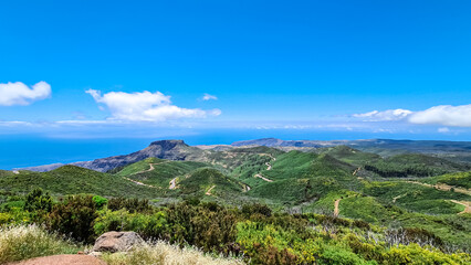 Fototapeta na wymiar Panoramic view on massive volcanic plug Fortaleza de Chipude overlooking western coast of La Gomera, Canary Islands, Spain, Europe. Atlantic Ocean in background. Hilly mountain road to Valle Gran Rey