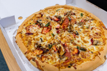 Newcastle England: 14th July 2022: Huge 14 inch spicy chicken tikka pizza from a takeaway. Very...