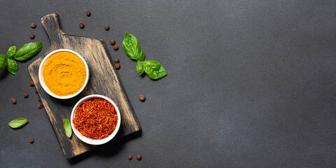 Assortment of aromatic herbs and spices on black rustic background with copy space for your design top view. - obrazy, fototapety, plakaty