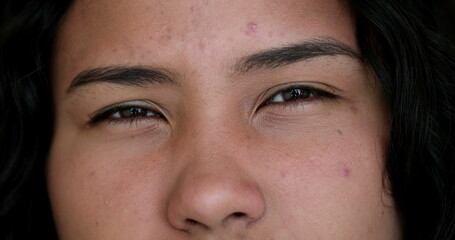 Doubtful girl eyes looking at camera squinting. Suspicious woman macro closeup