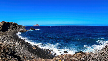 Panoramic view on the Red Mountain (La Montana Roja) from Santa Barbara Gold club near Golf del Sur, Tenerife, Canary Islands, Spain, Europe, EU. Coastline and stone beach of the Atlantic Ocean