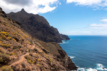 Panoramic view of Atlantic Ocean coastline and Anaga mountain range on Tenerife, Canary Islands, Spain, Europe, EU. Looking at Cabezo el Tablero crag. Scenic coastal hiking trail from Afur to Taganana