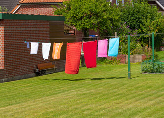 colorful towels hanging outdoors on a clothesline for drying