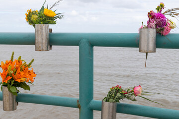 flowers in a box from survivors on a memorial place for deceased persons buried at sea