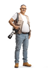 Full length portrait of a mature male photographer carrying a professional camera and smiling