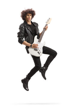 Male rock star playing a guitar and jumping