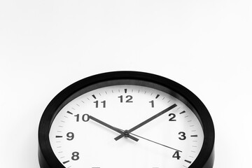 Round wall black and white clock. Time to work or rest concept
