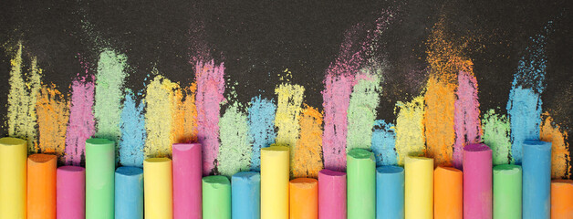 Multicolored chalk on black board. Back to school. Colored background. Banner - obrazy, fototapety, plakaty