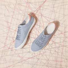 Stylish pastel sneakers isolated beige background