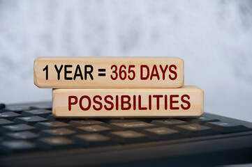 365 possibilities text on wooden blocks on top of keyboard. Motivational concept.
