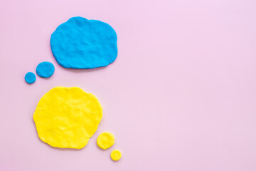 Commenication and messengers concept with text speech bubbles made of plasticine.