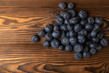 Blueberries on a brown texture background. Ripe and fresh blueberries. Vitamins. Healthy food. Juicy berry. Copy space. Place for text