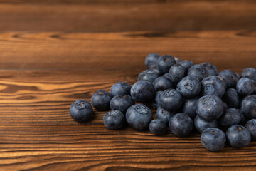 Blueberries on a brown texture background. Ripe and fresh blueberries. Vitamins. Healthy food. Juicy berry. Copy space. Place for text