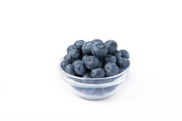 Blueberries in a bowl isolated on a white background. Ripe and fresh blueberries. Vitamins. Healthy food. Juicy berry. Copy space. Place for text