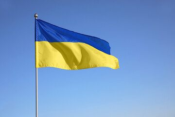 National flag of Ukraine against blue sky