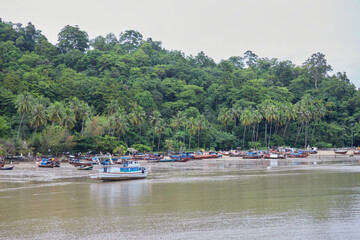 Fishing boats docking on the beach at Mu Ko Phetra in Thailand