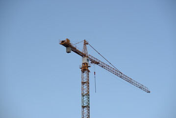 unfinished building against the background of the evening sky for banner, background, postcard, mail beautiful glass building, apartment building, cranes construction