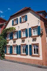 Fototapeta na wymiar View towards a pretty old house with blue shutters in Bad Bergzabern/Germany