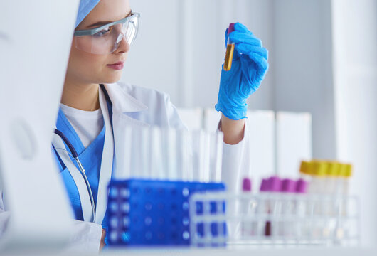 laboratory assistant woman analyzing a blood sample