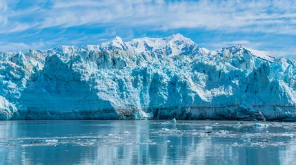 Selbstklebende Fototapeten A view past icy waters towards the snout of the Hubbard Glacier in Alaska in summertime © Nicola