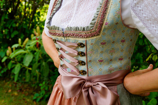 a woman in a beautiful traditional Bavarian dirndl or also Austrian dirndl dress (also called Tracht) at the Bavarian October fest (Oktoberfest) (Munich, Bavaria, Germany)	