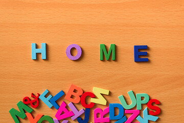 The word Home in colored letters on a wooden background