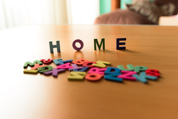 The word Home in colored letters on a wooden background