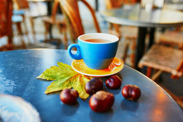 Cup of fresh espresso coffee on a table of traditional outdoor cafe in Paris, France