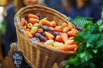 Fresh healthy bio parsnip and colorful carrots on London farmer market