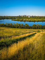 Fototapeta premium Habitat Conservation Area and Cityscape at sunrise over Wascana Lake and Prairie in Regina, Saskatchewan, Canada
