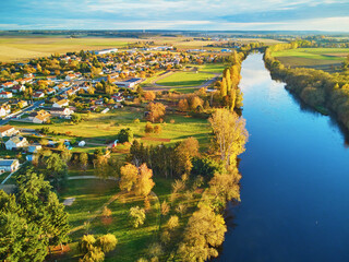 Autumn forest and river Vienne near medieval castle of Les Ormes, France