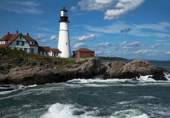 Fototapeta na wymiar Rolling Clouds and Surf at Portland Head Lighthouse in Maine