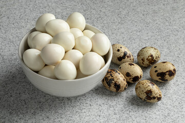 Cooked and fresh raw Quail eggs close up
