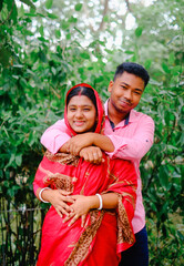 South asian newly married couple with traditional dress, husband and wife in a outdoor natural...