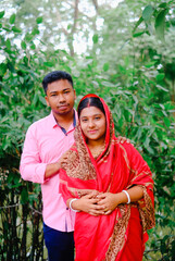 South asian newly married couple with traditional dress, husband and wife in a outdoor natural...