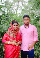 South asian newly married couple with traditional dress, husband and wife in a outdoor natural environment 