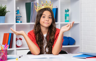 Funny face. Portrait of ambitious teenage girl with crown, feeling princess, confidence. Child princess crown at home.