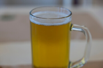 Close up view of mug of cold beer isolated on background.