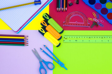 Back to school concept. Group of school office supplies on colorful background, pencils, notebooks,...