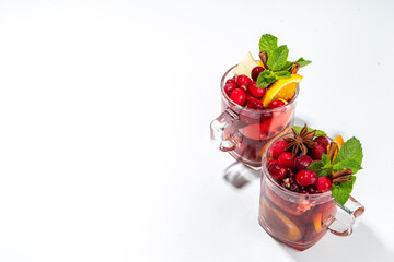 Christmas mulled wine with aromatic spices and citrus fruits and berry. Hot autumn winter fruity punch drink with red wine, on white background copy space