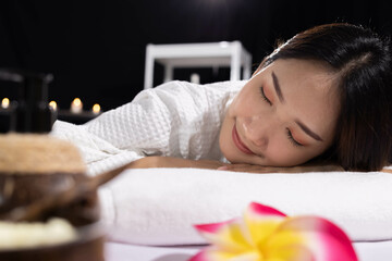 An Asian girl sleep with smile and relaxing in spa salon