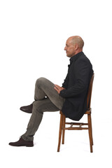 side view of a full portrait of a man sitting on chair with cross-legged on white background